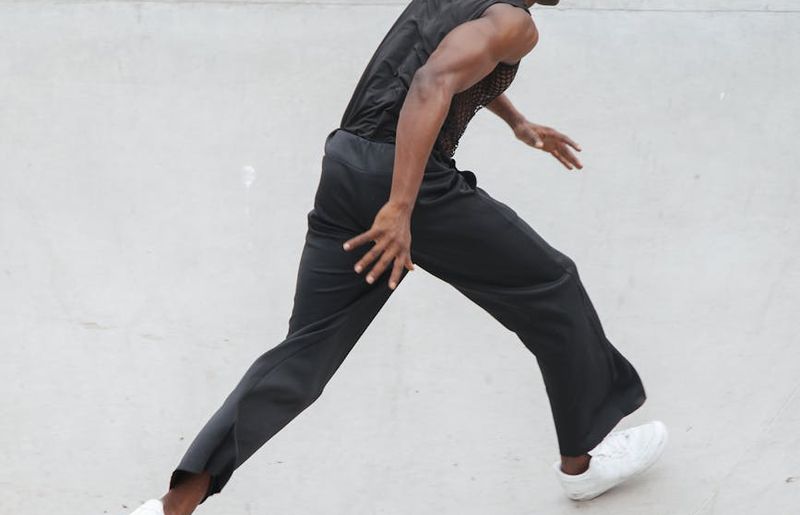 A person mid-stride during a cardio exercise in a spacious hall.