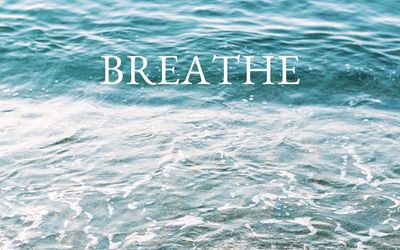 Person breathing deeply with closed eyes before a workout.