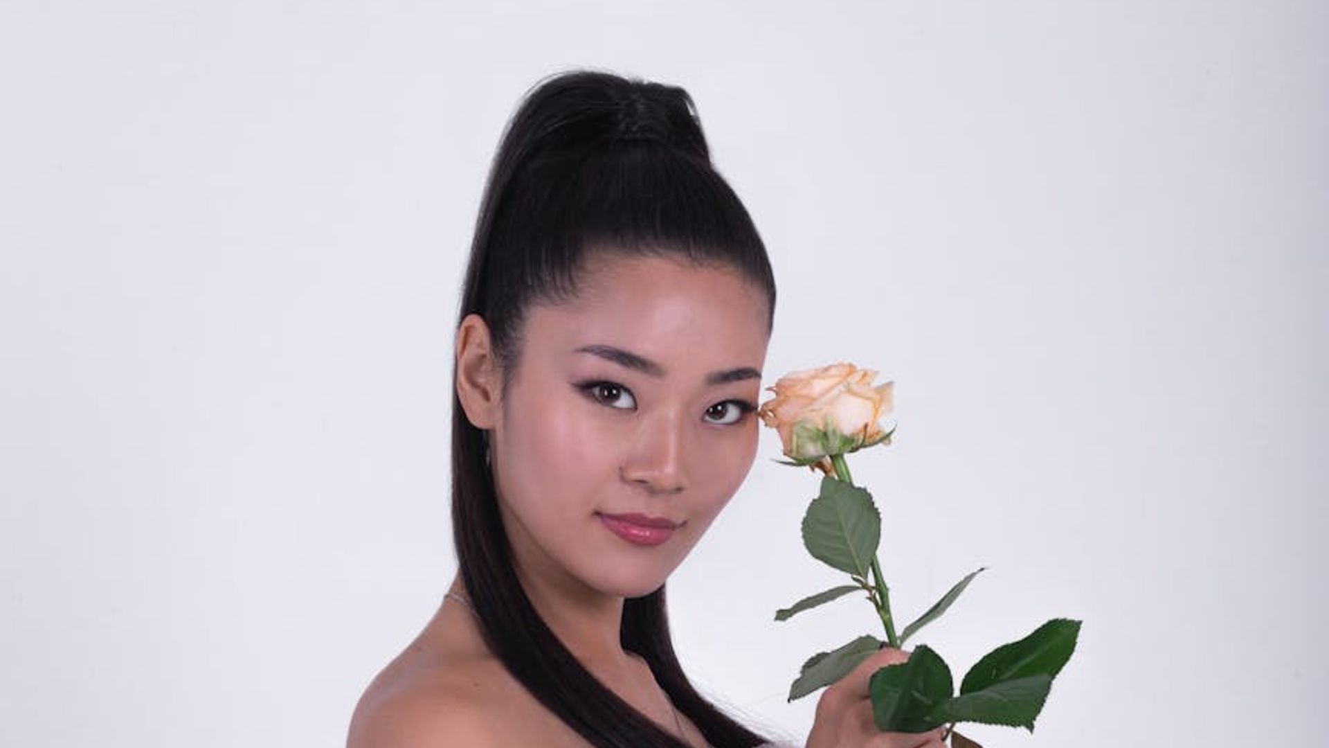 Person in a dynamic cardio pose in a minimalist dark room.